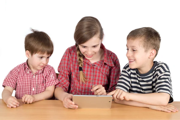Happy Siblings Sitting at the Desk and Using Tablet Isolated — Stock fotografie