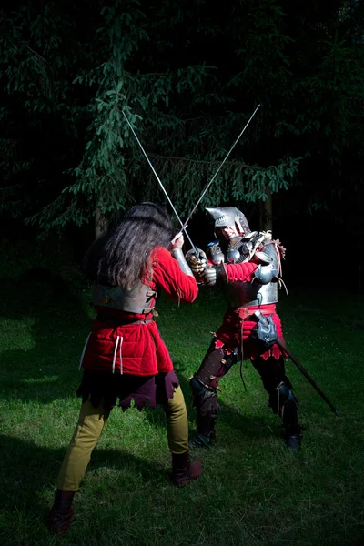 Två riddare fäktning i skogen på natten — Stockfoto