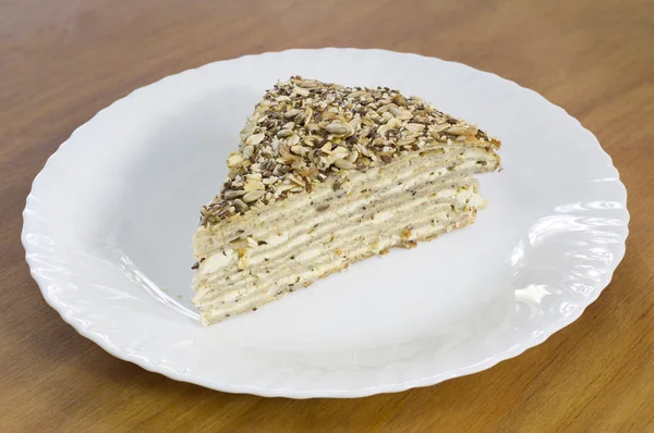 Delicious Piece of Buckwheat Pie Filled With Cheese and Seeds on Top on White Plate — Stock Photo, Image