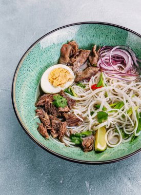 Beton arka planda kasede sığır etli Pho Bo Vietnam Çorbası