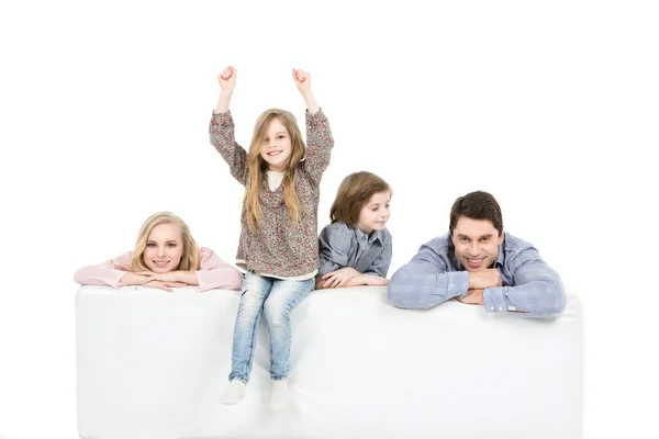 Family relaxing on sofa isolated on white. Stock Image