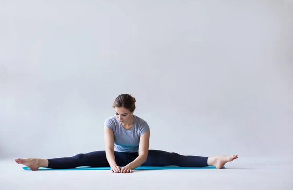 Kvinna Sportkläder Yogamatta Stretchar Övningar Grå Bakgrund — Stockfoto