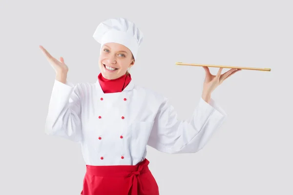 Smiling and cheerful female chef, cook or baker in uniform and hat isolated — Stock Photo, Image