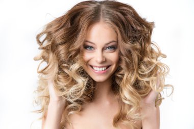 Portrait of beautiful young smiling girl with luxuriant hair curling. Health and Beauty. clipart