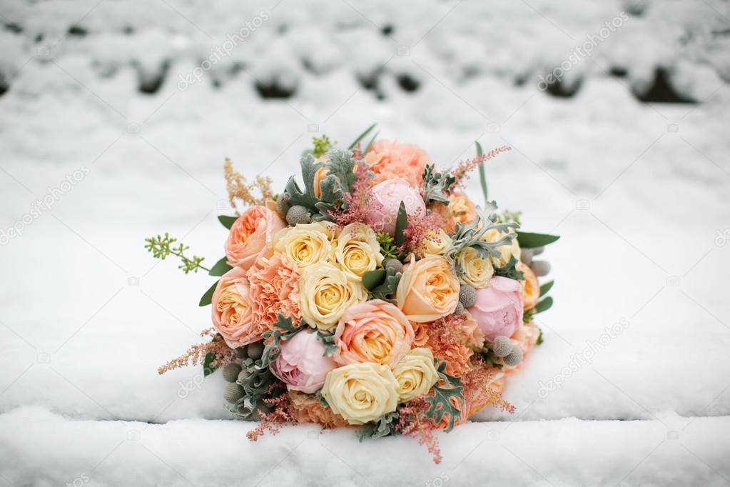 Wedding flowers closeup. Bridal bouquet in the snow.
