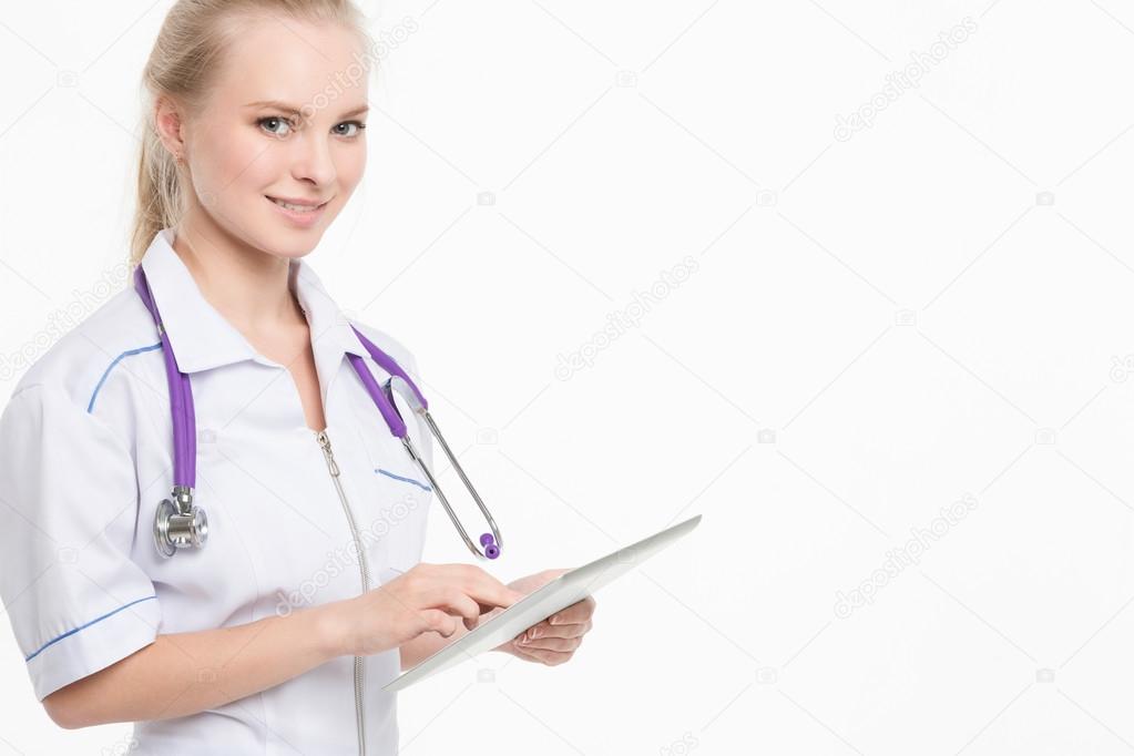 beautiful young female medical intern with tablet computer 