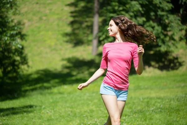 Young beautiful woman running in the park — Stock Photo, Image