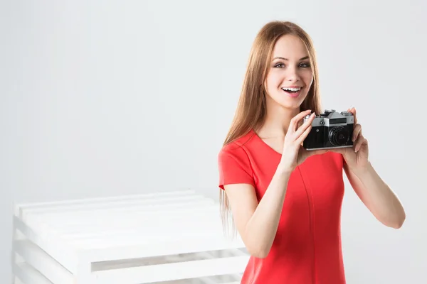 Smiling girl with camera — Stock Photo, Image