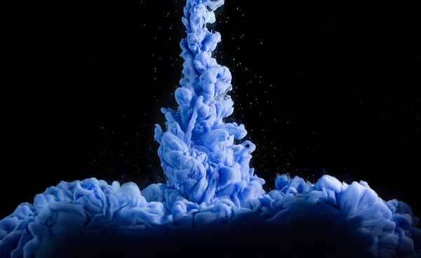 Blue ink in water on dark background. — Stock Photo, Image