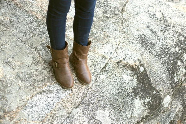 Botas de uma mulher andando sobre uma rocha — Fotografia de Stock