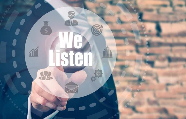 Businessman selecting a We Listen button — Stock Photo, Image