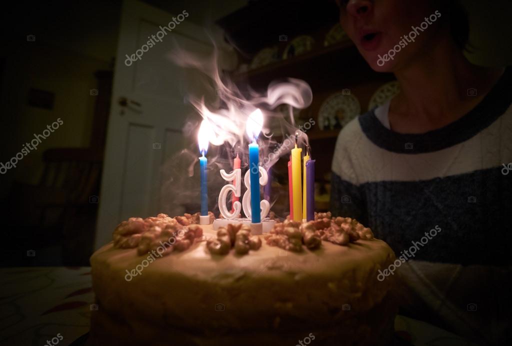 Blowing out candles on a birthday cake — Stock Photo © IzelPhotography