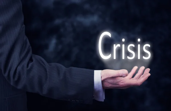 Ręka trzyma słowo kryzys. — Zdjęcie stockowe