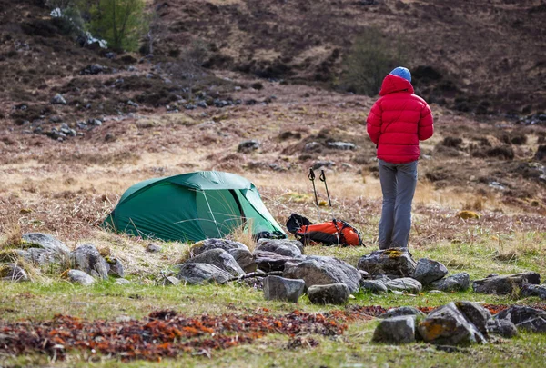 Hiker and pitched tent