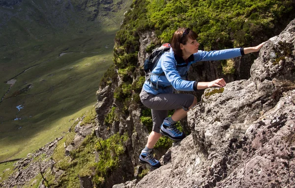 Ženské lezec lézt nahoru na útes — Stock fotografie