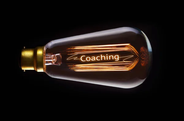 Coaching Concept in retro filament lightbulb — Stock Photo, Image