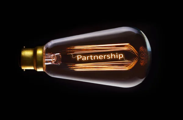 Partnership Concept in retro filament lightbulb — Stock Photo, Image