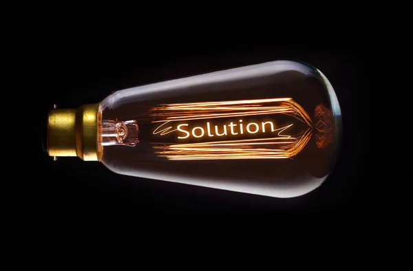 Solution Concept in retro filament lightbulb — Stock Photo, Image