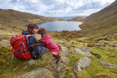 Female hiker and her dog clipart