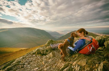 Kadın uzun yürüyüşe çıkan kimse ve dinlenme köpeği