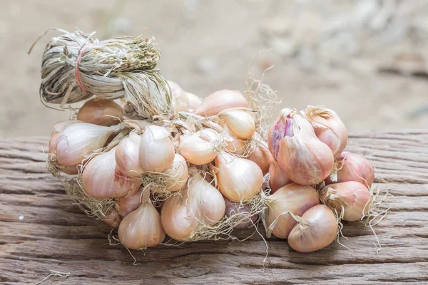 Shallots on wooden table. — Stock Photo, Image