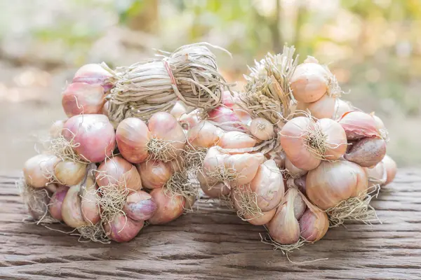 Shallots on wooden table. — Stock Photo, Image