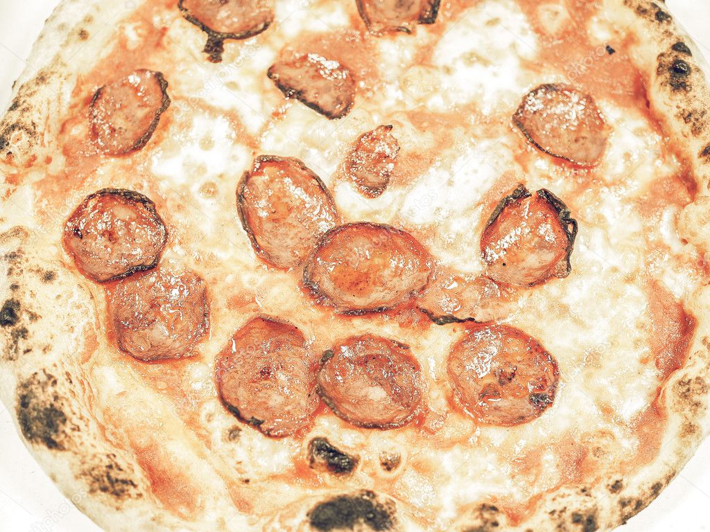 Vintage faded Pepperoni pizza aka diavola traditional Italian pizza useful as a background