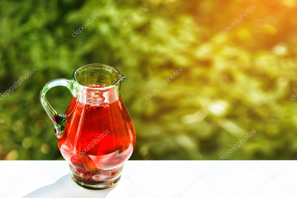 Green jar of cranberry lemonade outdoor. Shallow depth of field.