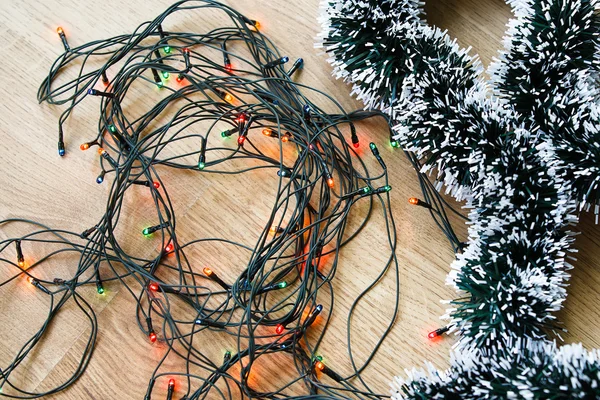 Light and decorative garlands on wooden background — Stock Photo, Image