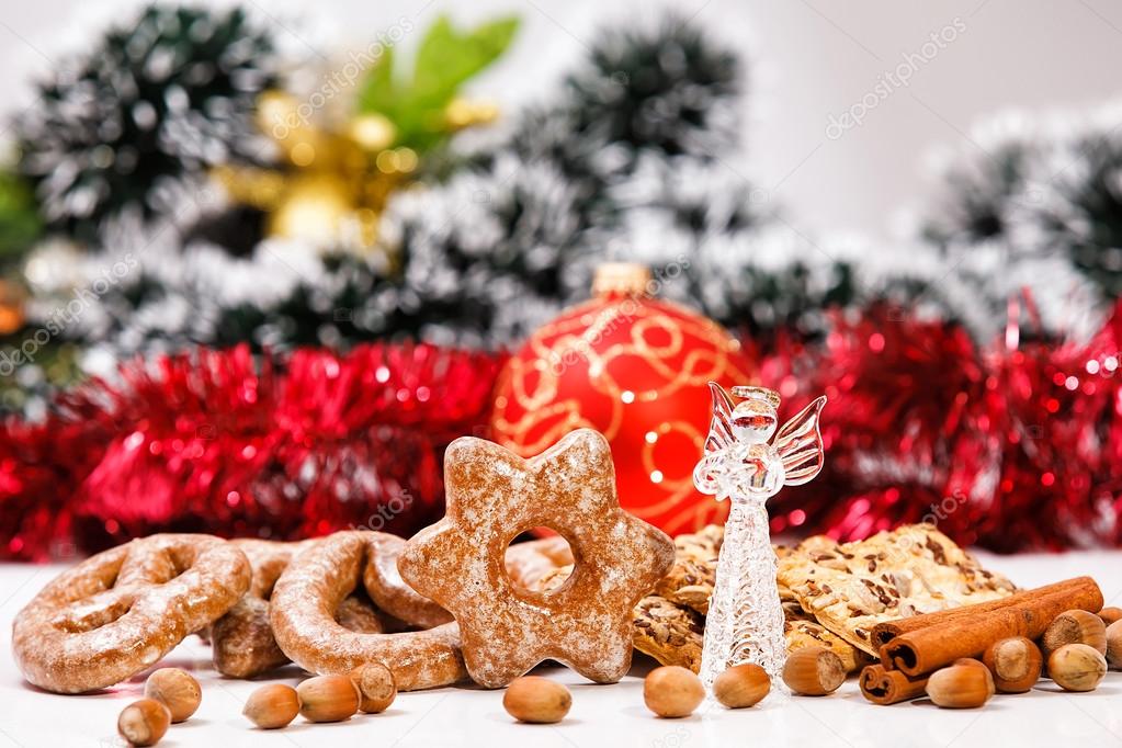 Cookies and decorative glass angel on de-focused christmas theme