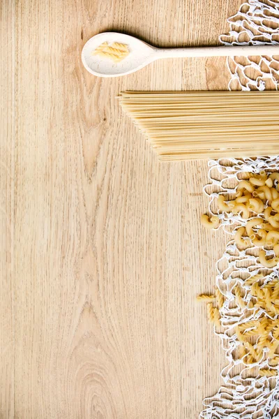 Wood spoon, different pasta — Stock Photo, Image