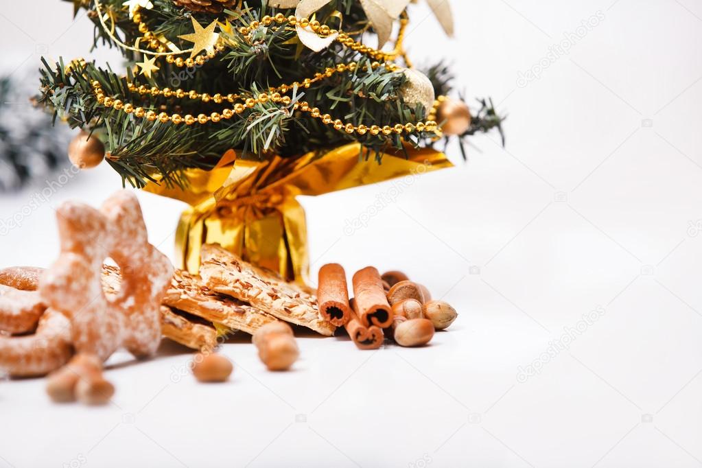 Cookies and nuts on Christmas theme background.