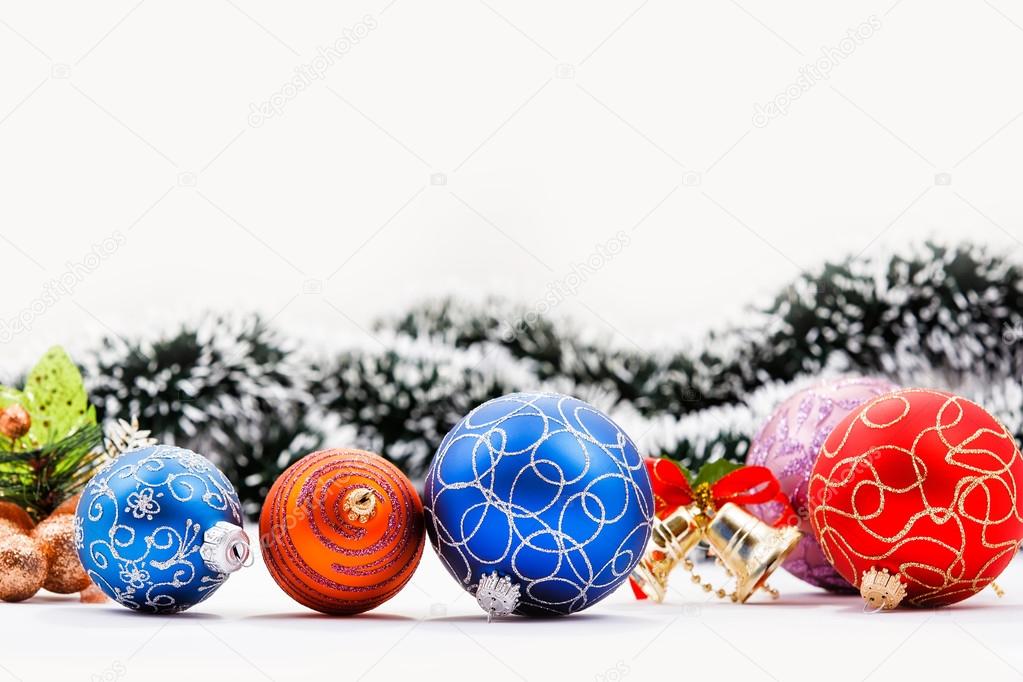 Christmas balls. Garland and Christmas bell in background.