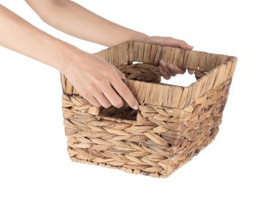 Boş hasır sepeti tutan eller beyaz arkaplanda izole edildi