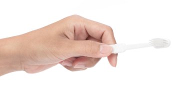 El ele tutuşarak beyaz bir arkaplanda izole edilmiş diş fırçasını kapat