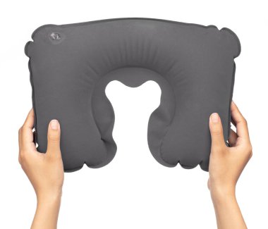 hand holding Grey neck pillow isolated on a white background