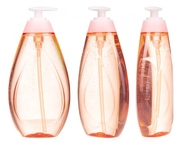 Beyaz zemin üzerinde sıvı sabun bulunan plastik şişe seti.