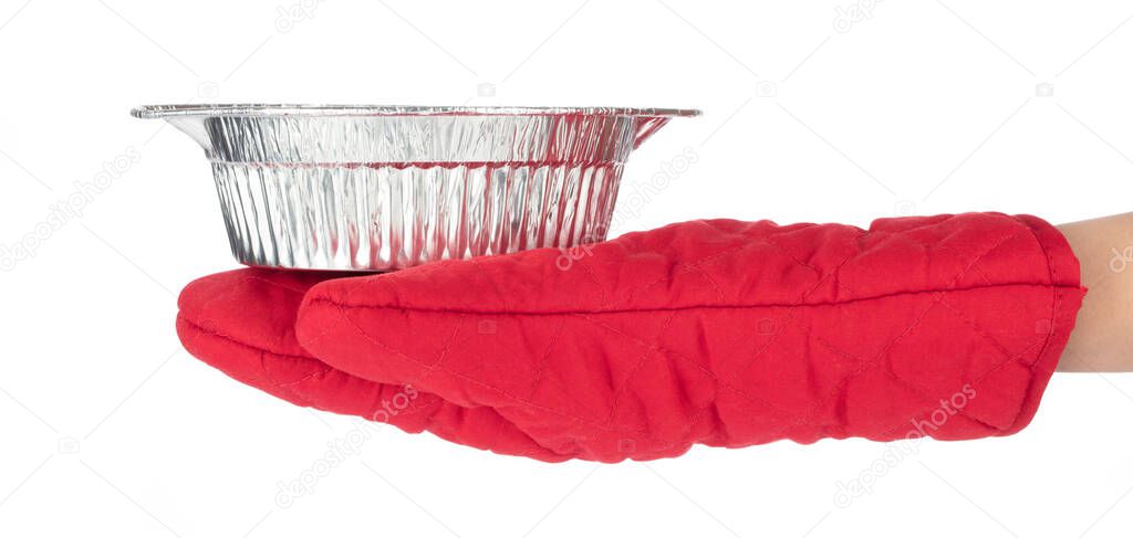 Woman wearing red gloves protect her hands holding foil bowl isolated on a white background.