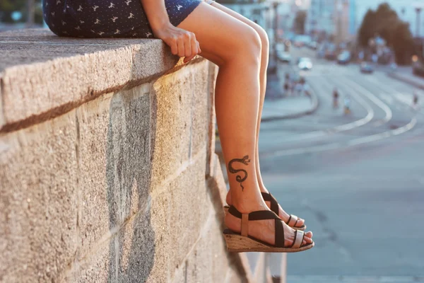Female legs with tattoo — Stock Photo, Image
