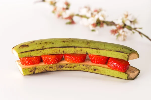 Bananas stuffed with cream and strawberries — Stock Photo, Image