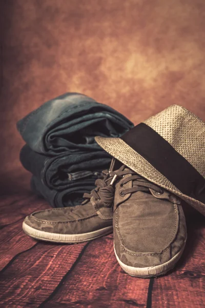 Clothing and fashion accessories on wooden table — Stock Photo, Image