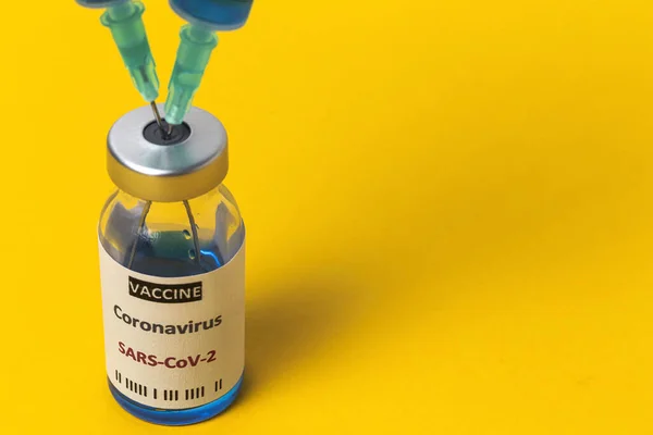 透明玻璃瓶与测试Covid 19疫苗 注射器在彩色背景 选定重点 — 图库照片