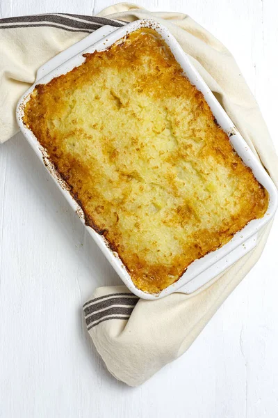 stock image Traditional homemade shepherd pie on white background from above. Cottage foot. English food concept