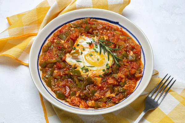 Vegetable dish pisto manchego made of tomatoes, zucchini, peppers, onions with fried egg. Typical Spanish food