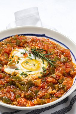 Vegetable dish pisto manchego made of tomatoes, zucchini, peppers, onions with fried egg. Typical Spanish food clipart