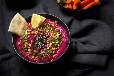  Sebzeli Pancar ve Nohut Humusu ve Karanlık Arkaplanda Mayasız Ekmek