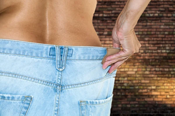 Woman with jeans topless making diet — Stock Photo, Image