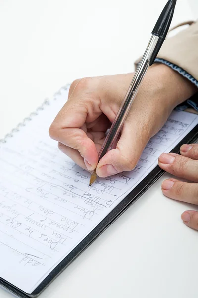 Woman hand writing in notebook Stock Picture