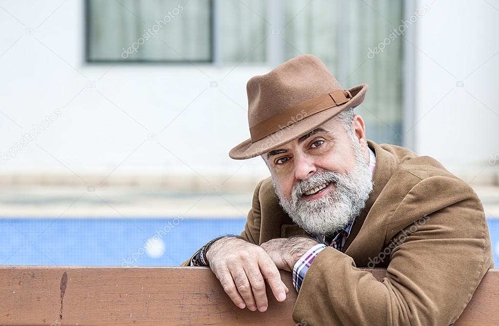 Attractive old man with beard and hat