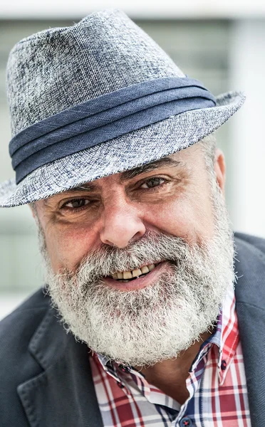 Attractive old man with beard and hat — Stock Photo, Image